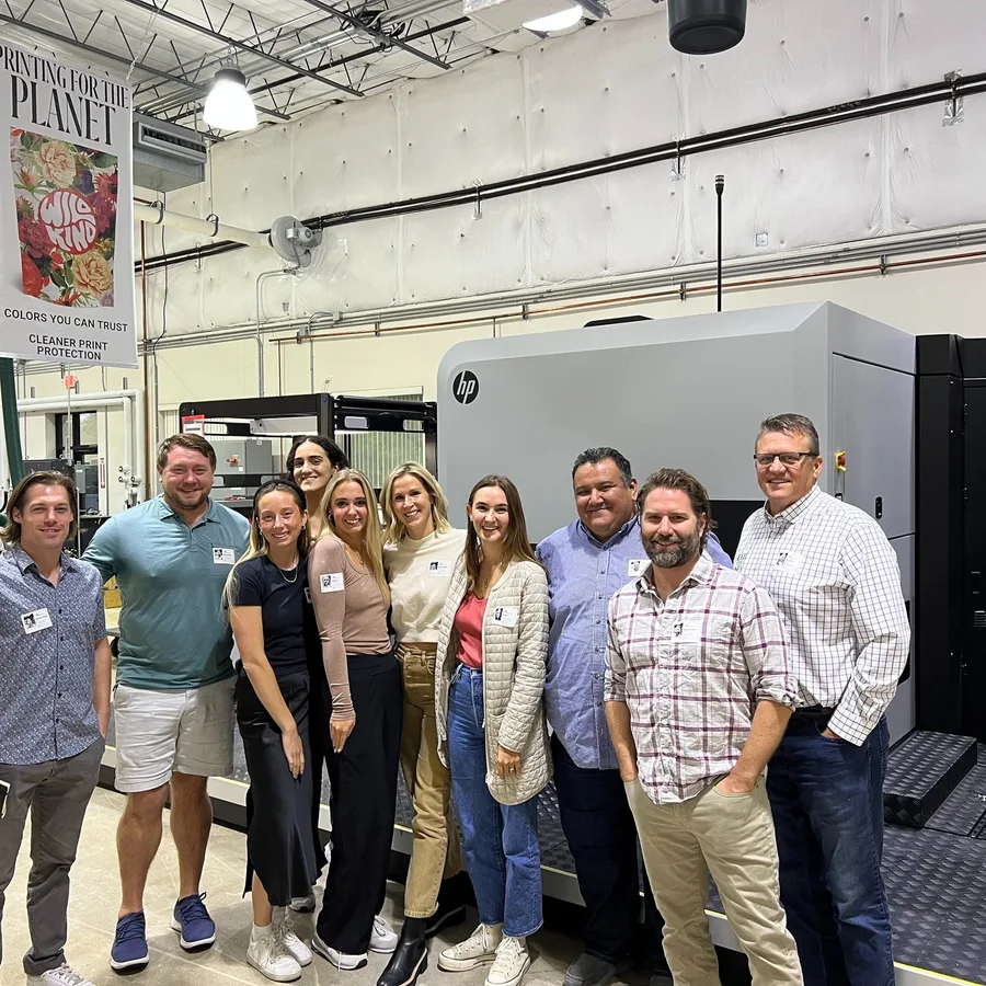 Community members posing for a group photo in an event space
