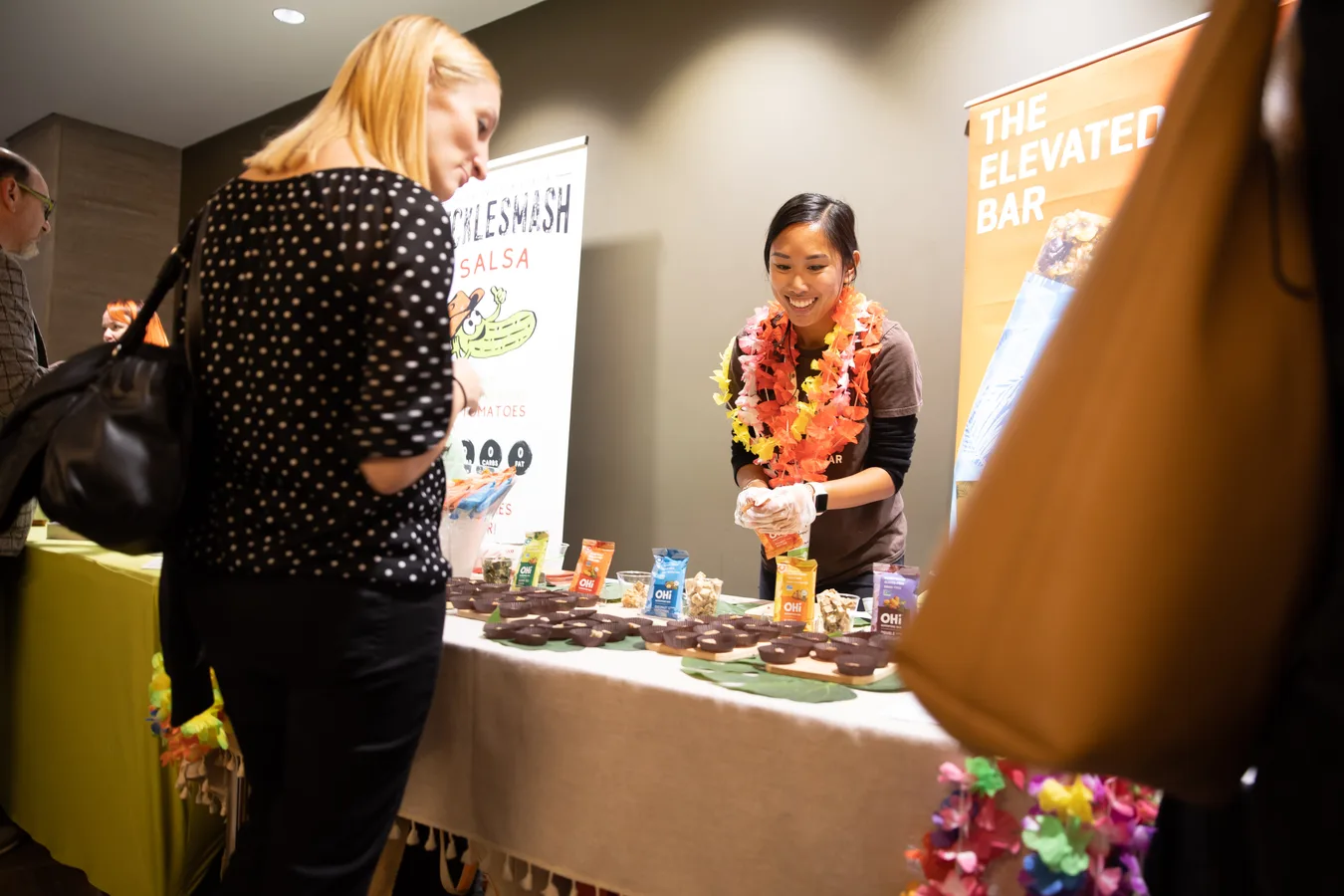 An attendee talking with a brand representative at a product table